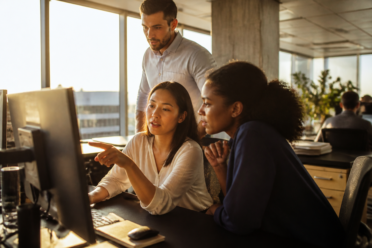 A payroll and operations team reviewing benefit schemes in a modern office.